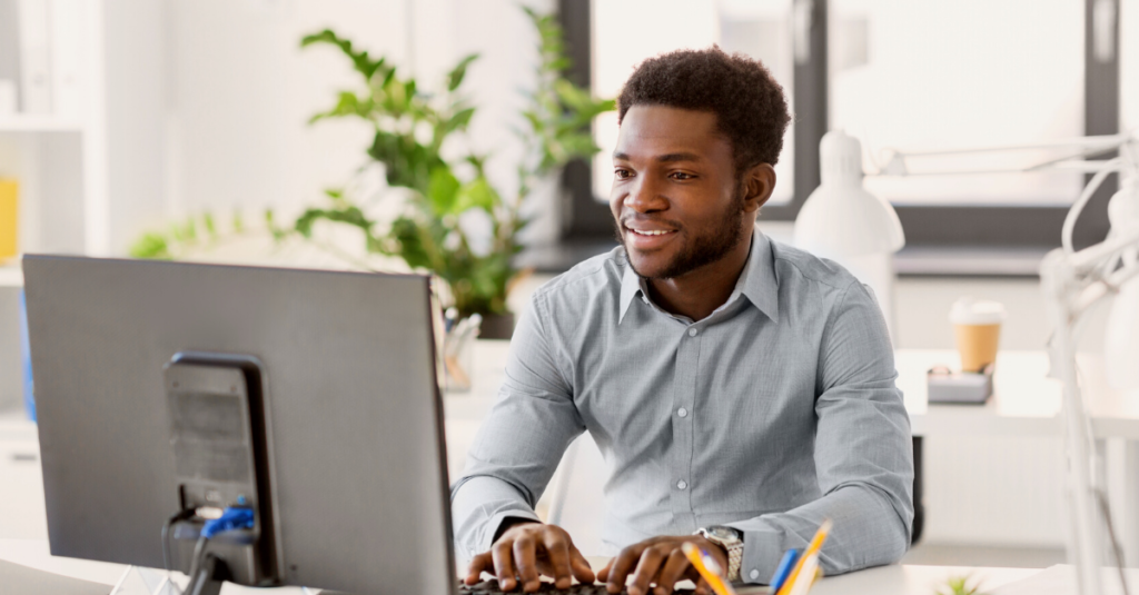 Man on Computer with plants behind him - ESP