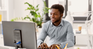 Man on Computer with plants behind him - ESP